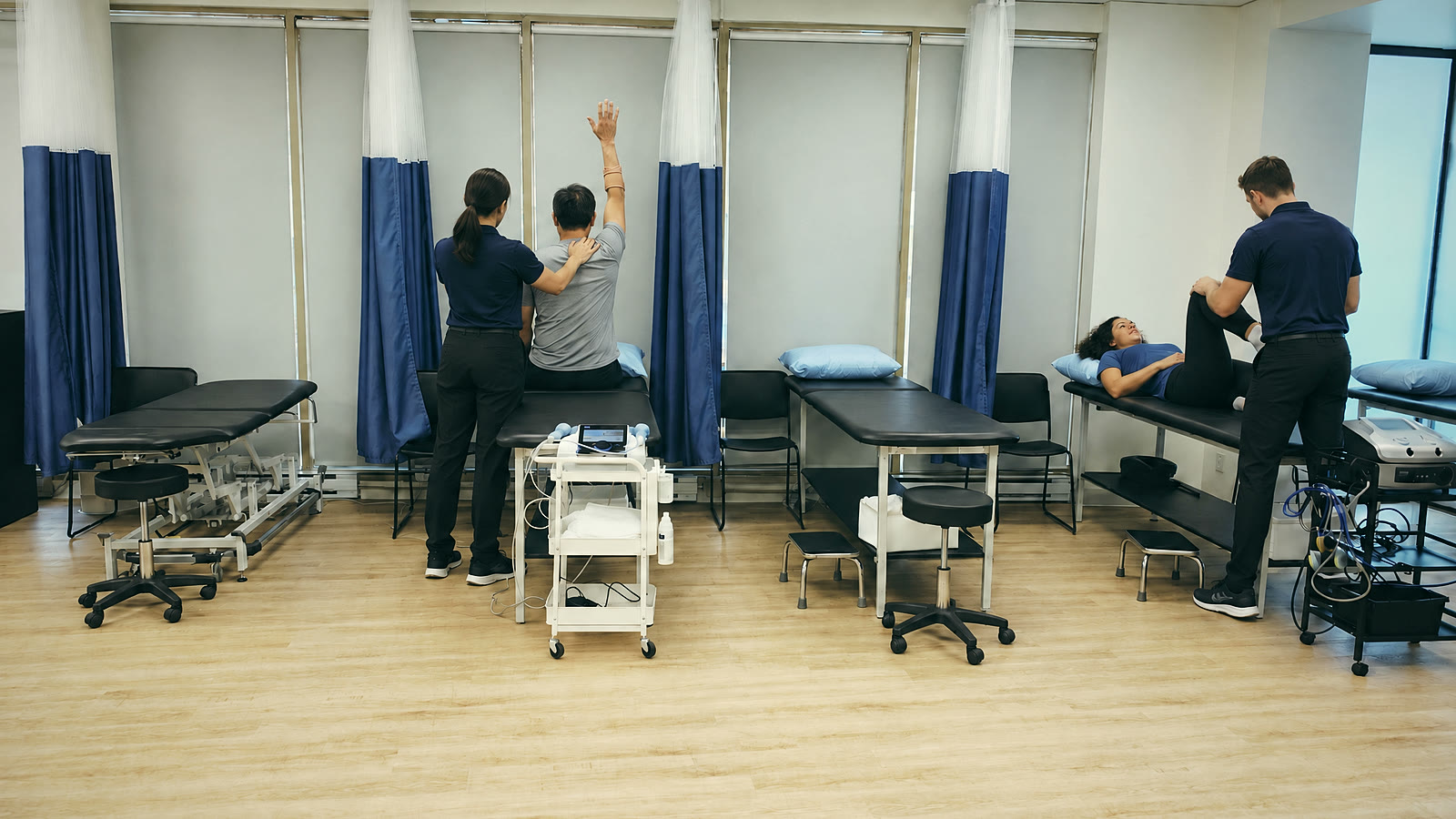 Two treatments under way in the four-bay treatment room at Dena Sports Physio, Mont-Royal